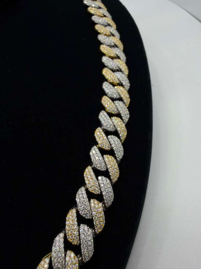 Gold and silver chain necklace on a black and white background